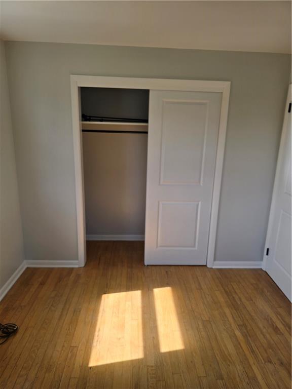 1681 Robbins Station Road Irwin, PA 15642 - Photo 21 of 27 a view of an empty room with wooden floor and a window