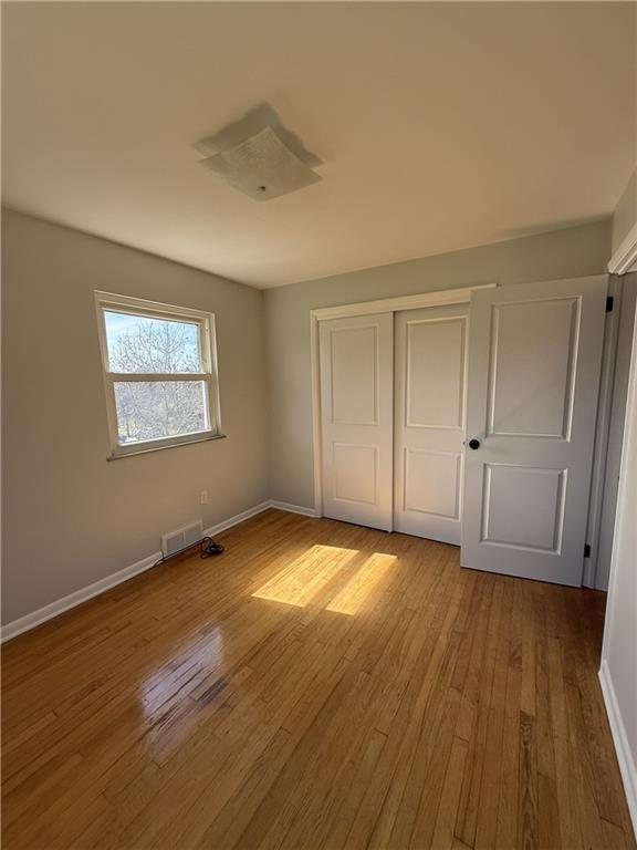 1681 Robbins Station Road Irwin, PA 15642 - Photo 22 of 27 a view of an empty room with wooden floor and a window