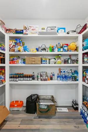 a shelf with food and items on wooden floor