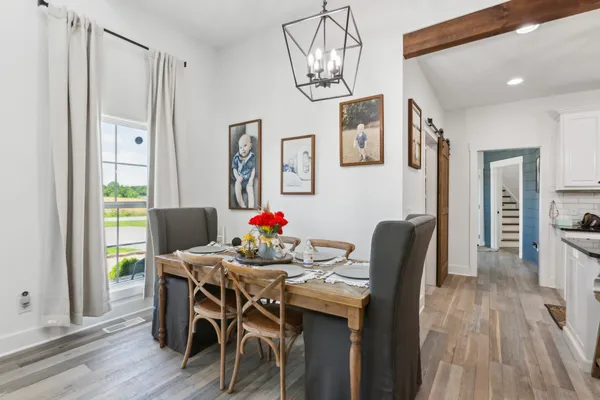 a dining room with furniture and wooden floor