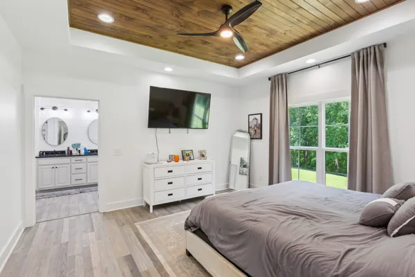 a bedroom with a bed and flat screen tv