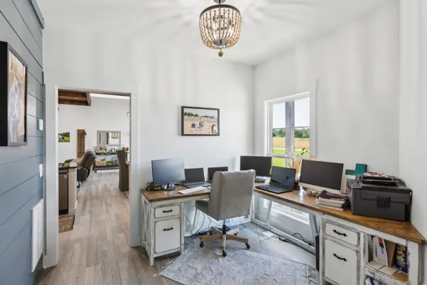 a workspace with furniture and wooden floor