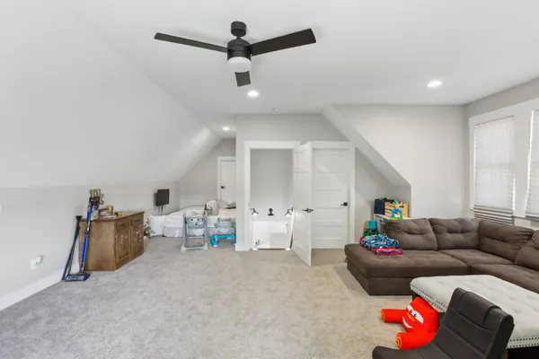 a living room with furniture and kitchen view