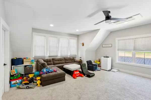 a living room with furniture a air conditioner vent and a window