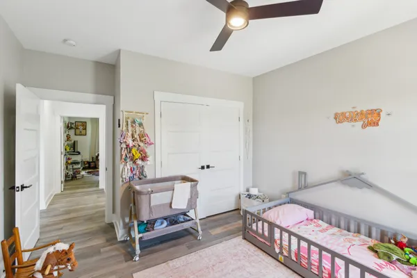 a bedroom with a bed and wooden floor