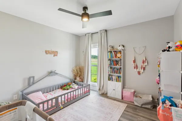 a bedroom with furniture and baby crib