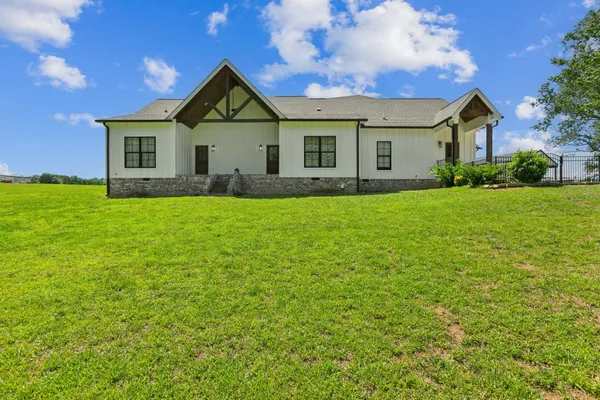 a front view of a house with yard and green space