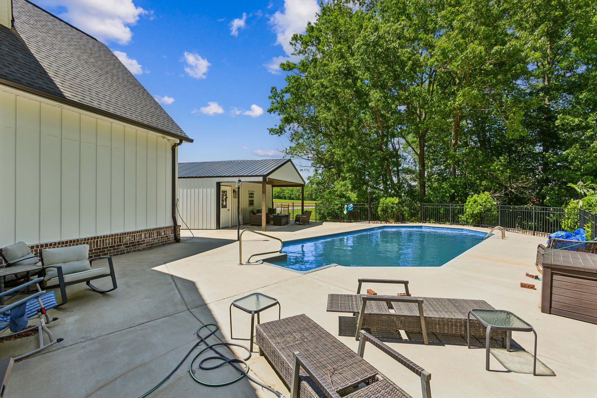 1930 Williams Road Lafayette, TN 37083 - Photo 38 of 41 a view of a patio with table and chairs with wooden fence and plants