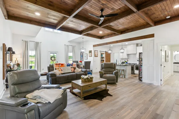 a living room with furniture and wooden floors