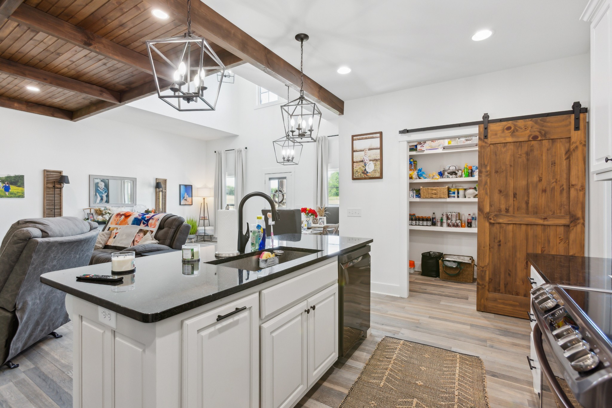 1930 Williams Road Lafayette, TN 37083 - Photo 10 of 41 a kitchen with a sink dishwasher a dining table and chairs with wooden floor