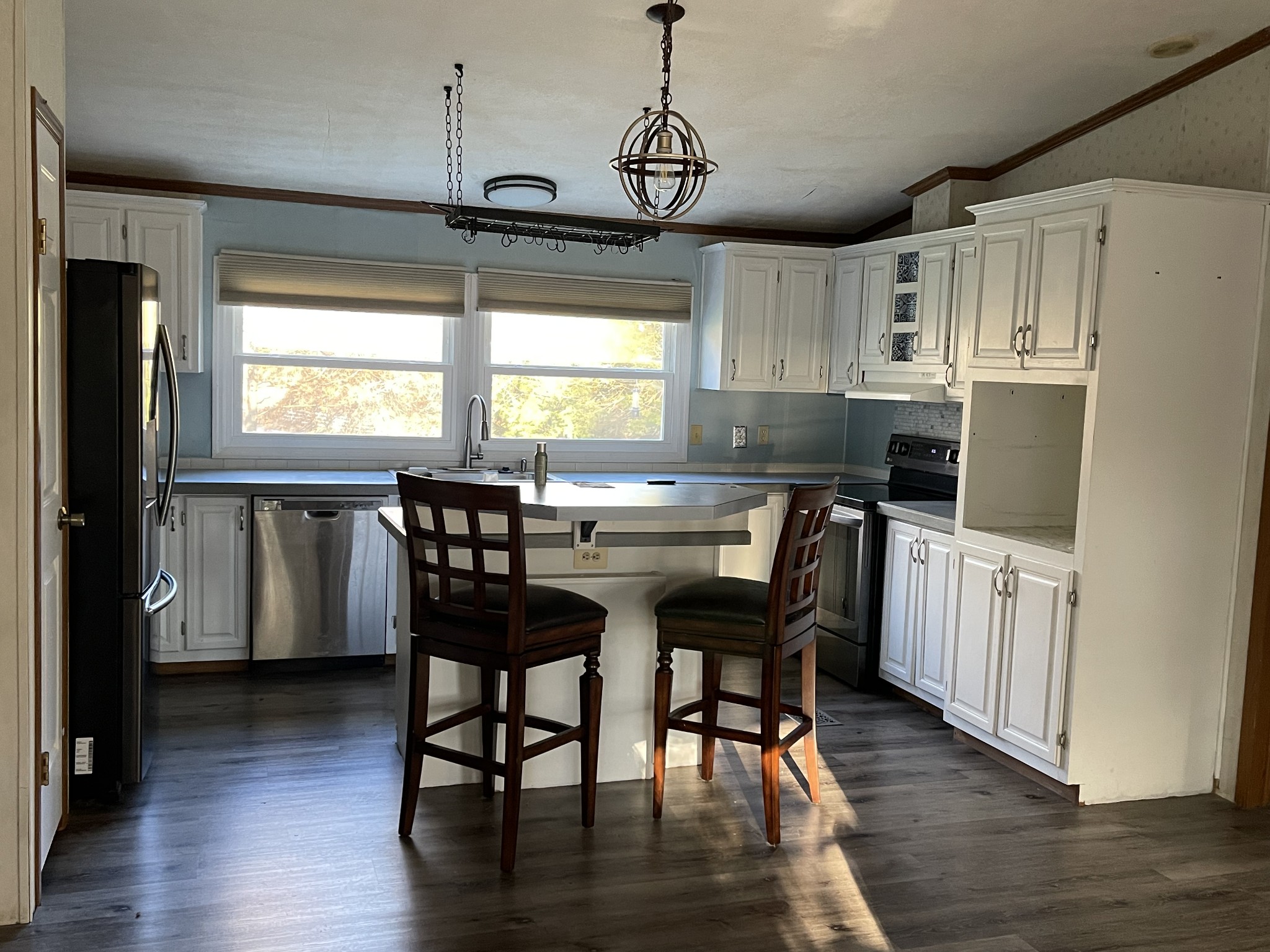 274 Hester Road Portland, TN 37148 - Photo 17 of 18 a kitchen with stainless steel appliances granite countertop wooden floor dining table and chairs