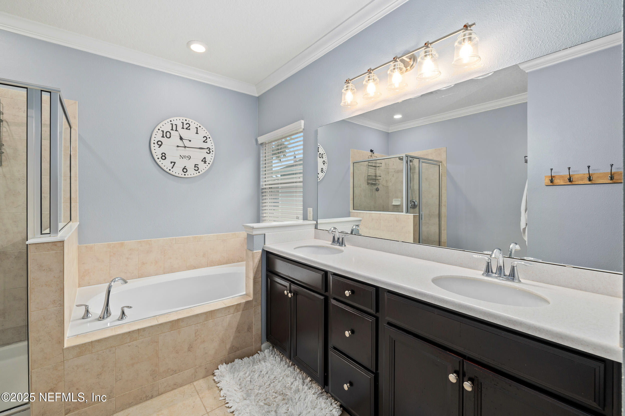 221 St Kitts Loop St. Augustine, FL 32092 - Photo 16 of 44 a spacious bathroom with a tub double sink and a mirror