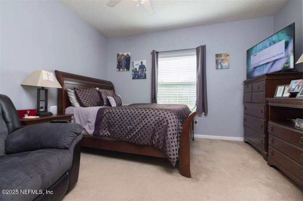 221 St Kitts Loop St. Augustine, FL 32092 - Photo 18 of 44 a bedroom with a bed and a window