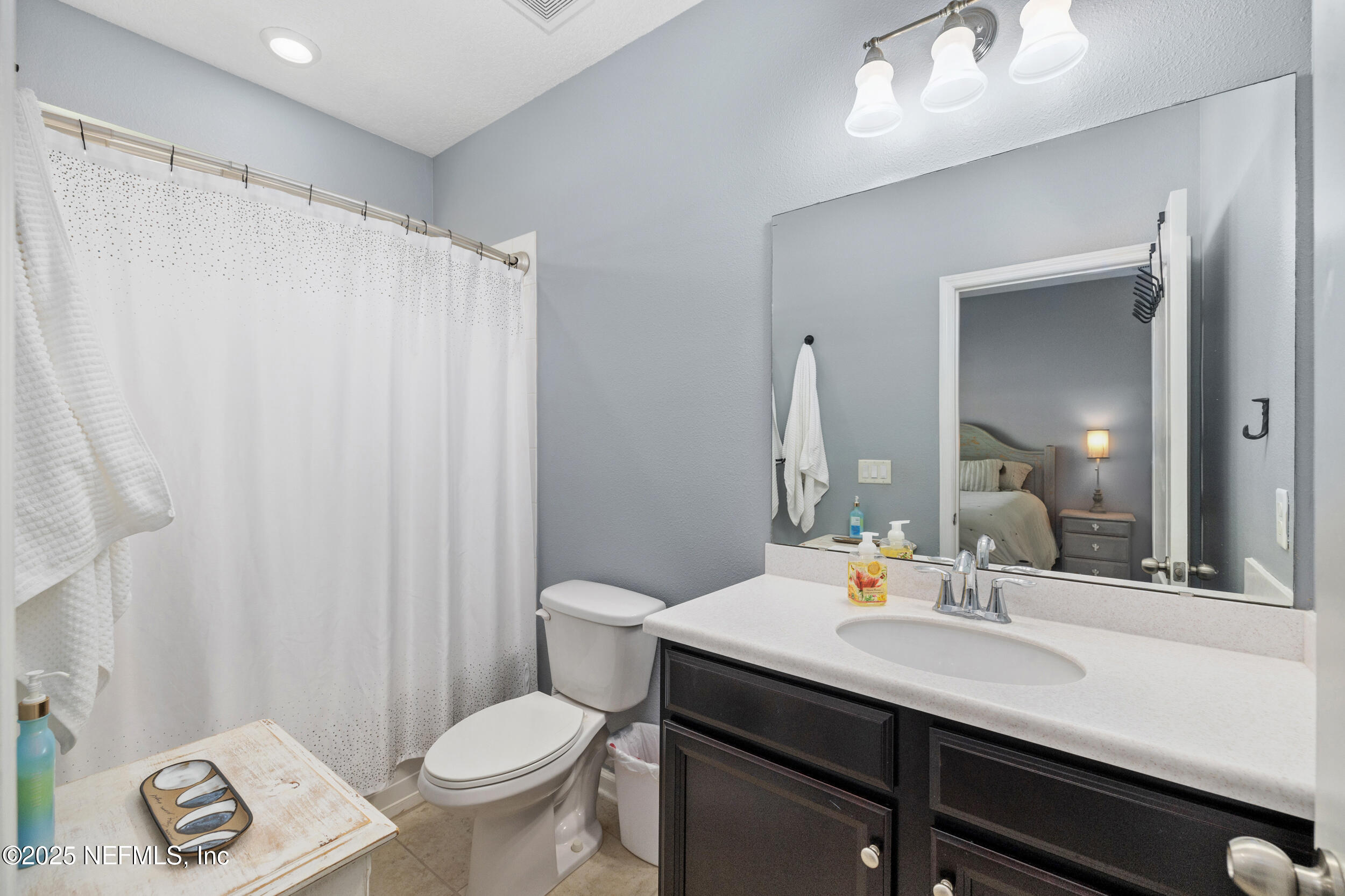 221 St Kitts Loop St. Augustine, FL 32092 - Photo 19 of 44 a bathroom with a sink toilet and shower