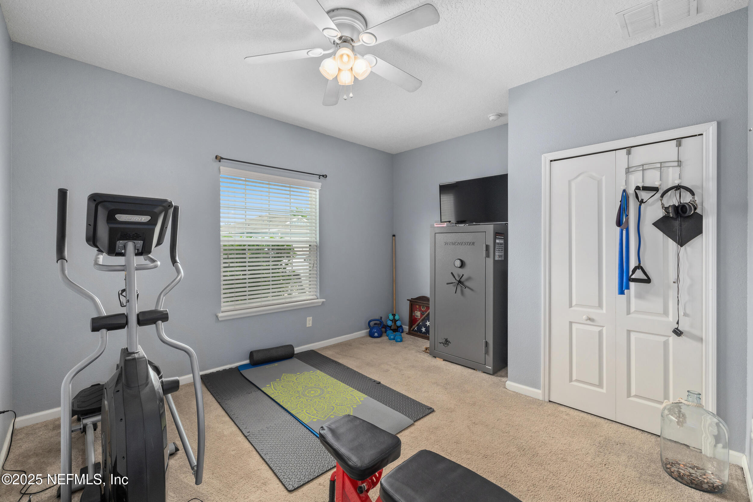 221 St Kitts Loop St. Augustine, FL 32092 - Photo 22 of 44 a room with furniture and a flat screen tv