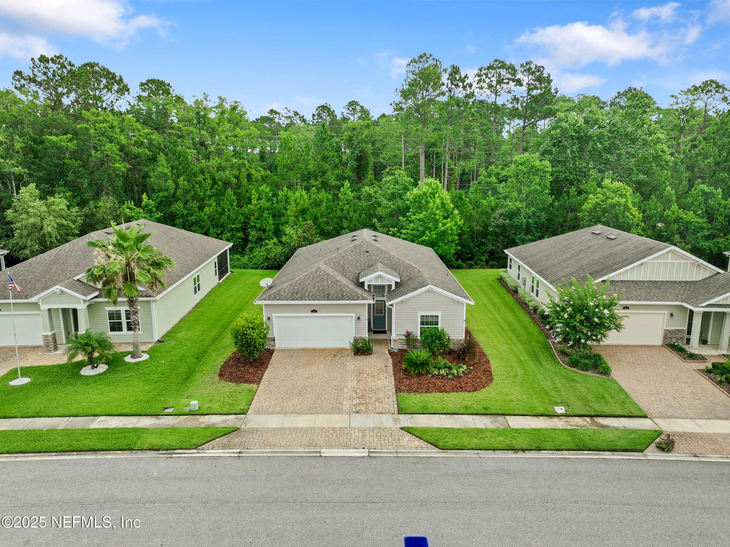 221 St Kitts Loop St. Augustine, FL 32092 - Photo 30 of 44 a front view of a house with a yard and trees