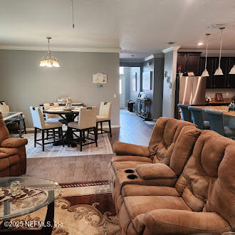 221 St Kitts Loop St. Augustine, FL 32092 - Photo 3 of 44 a living room with furniture a rug and kitchen view