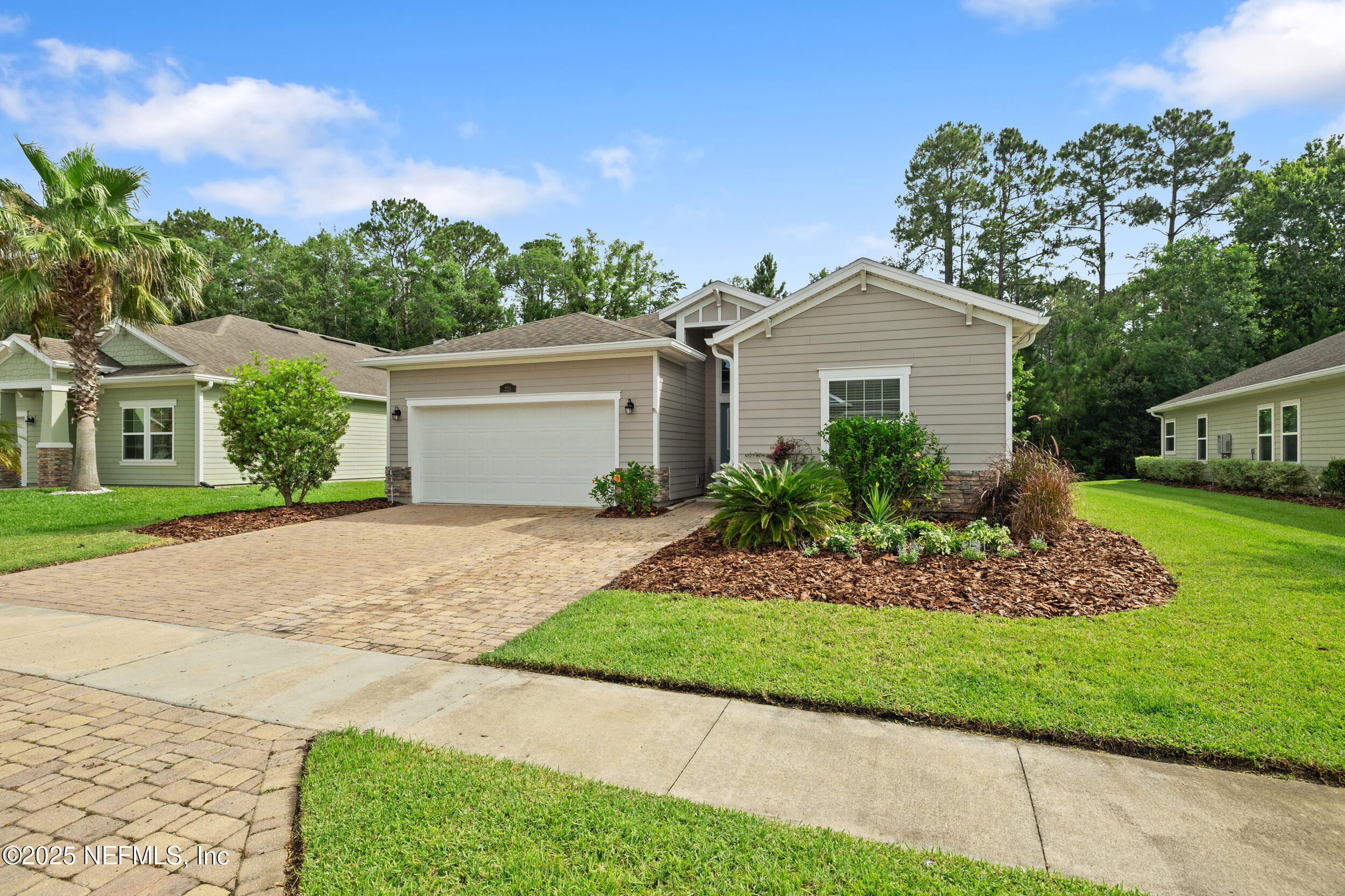 221 St Kitts Loop St. Augustine, FL 32092 - Photo 32 of 44 a front view of a house with a garden