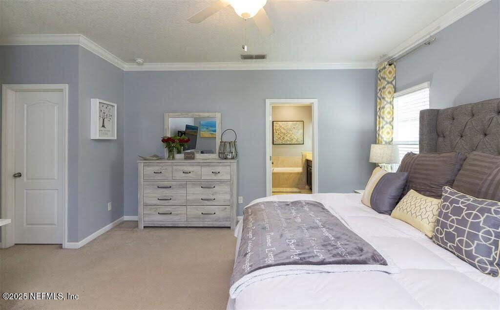 221 St Kitts Loop St. Augustine, FL 32092 - Photo 4 of 44 a bedroom with a bed and dresser