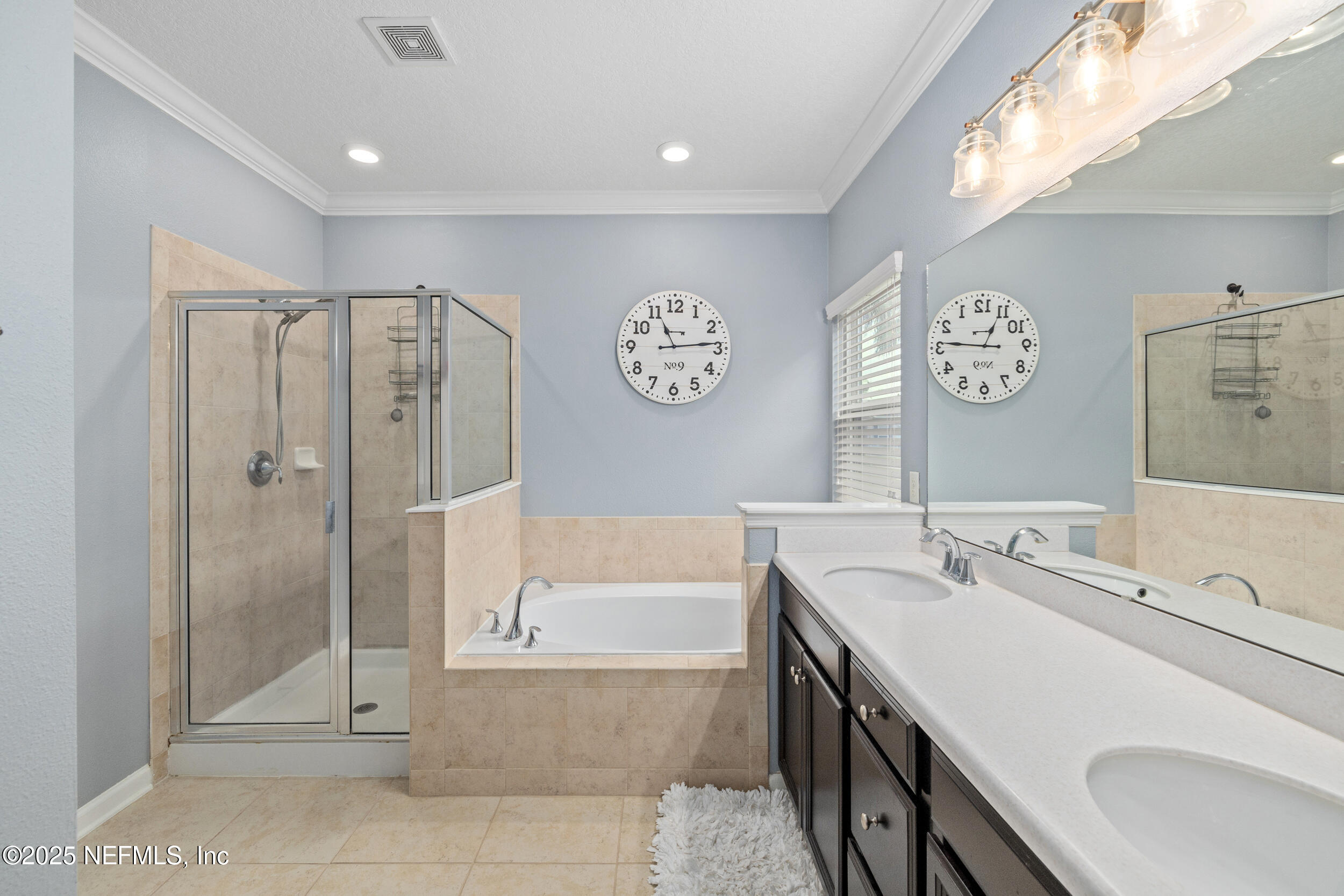 221 St Kitts Loop St. Augustine, FL 32092 - Photo 5 of 44 a spacious bathroom with a tub sink and mirror