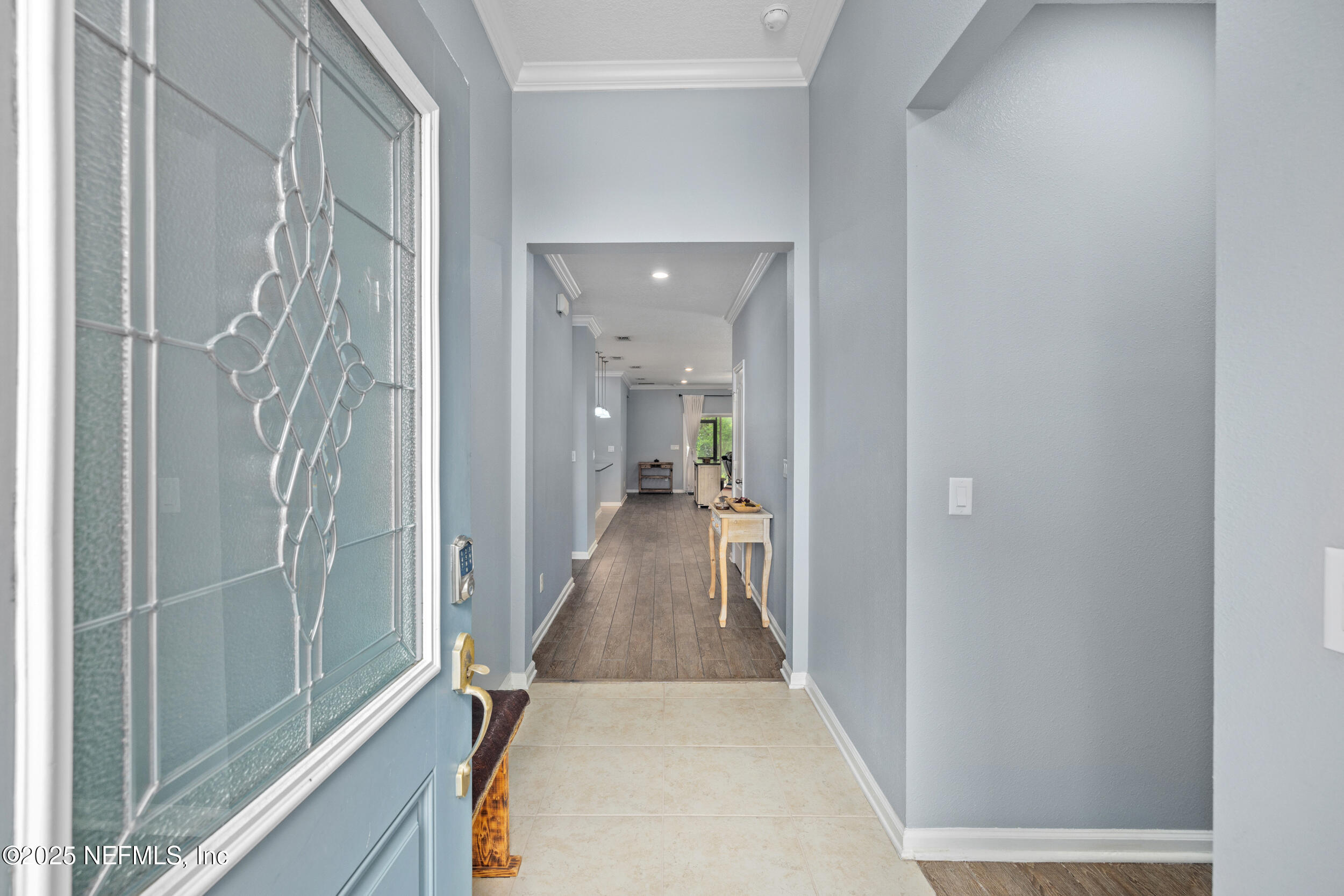 221 St Kitts Loop St. Augustine, FL 32092 - Photo 7 of 44 a view of a hallway with wooden floor and staircase