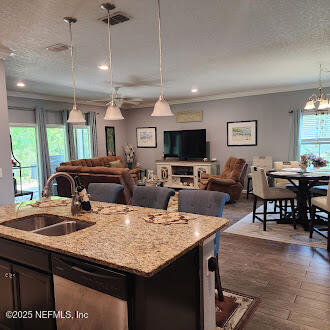 221 St Kitts Loop St. Augustine, FL 32092 - Photo 10 of 44 a kitchen with a stove a sink dishwasher a dining table and chairs with wooden floor