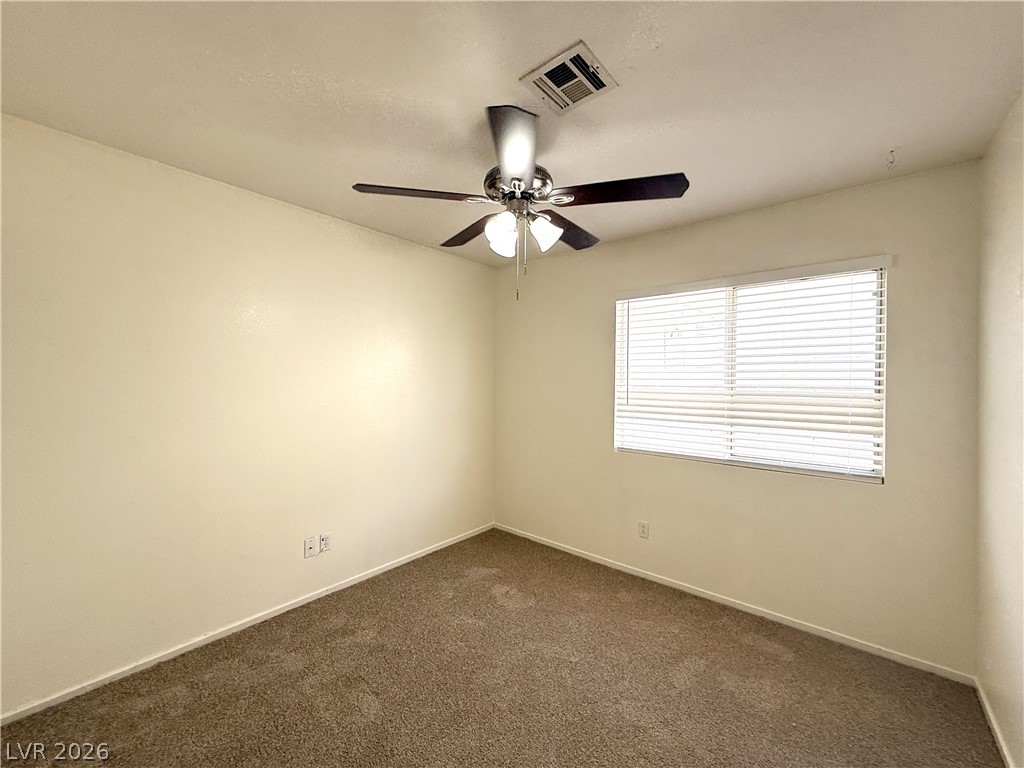 8870 Haviland Road Las Vegas, NV 89123 - Photo 14 of 22 An inviting sleeping space with warm neutral walls and cozy carpet, ready for personalization.