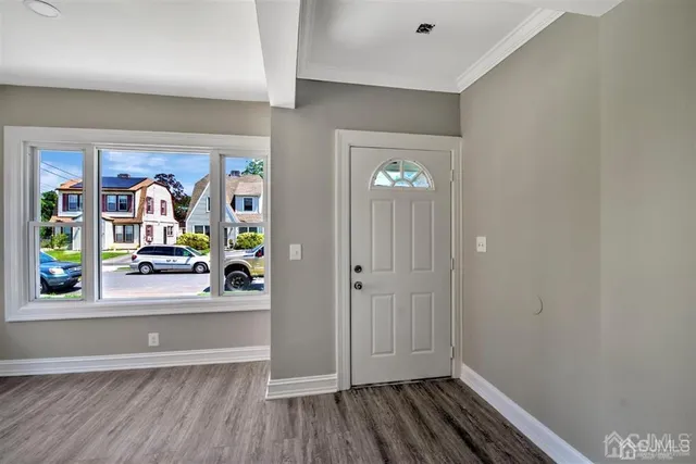 wooden floor with ceiling fan and window