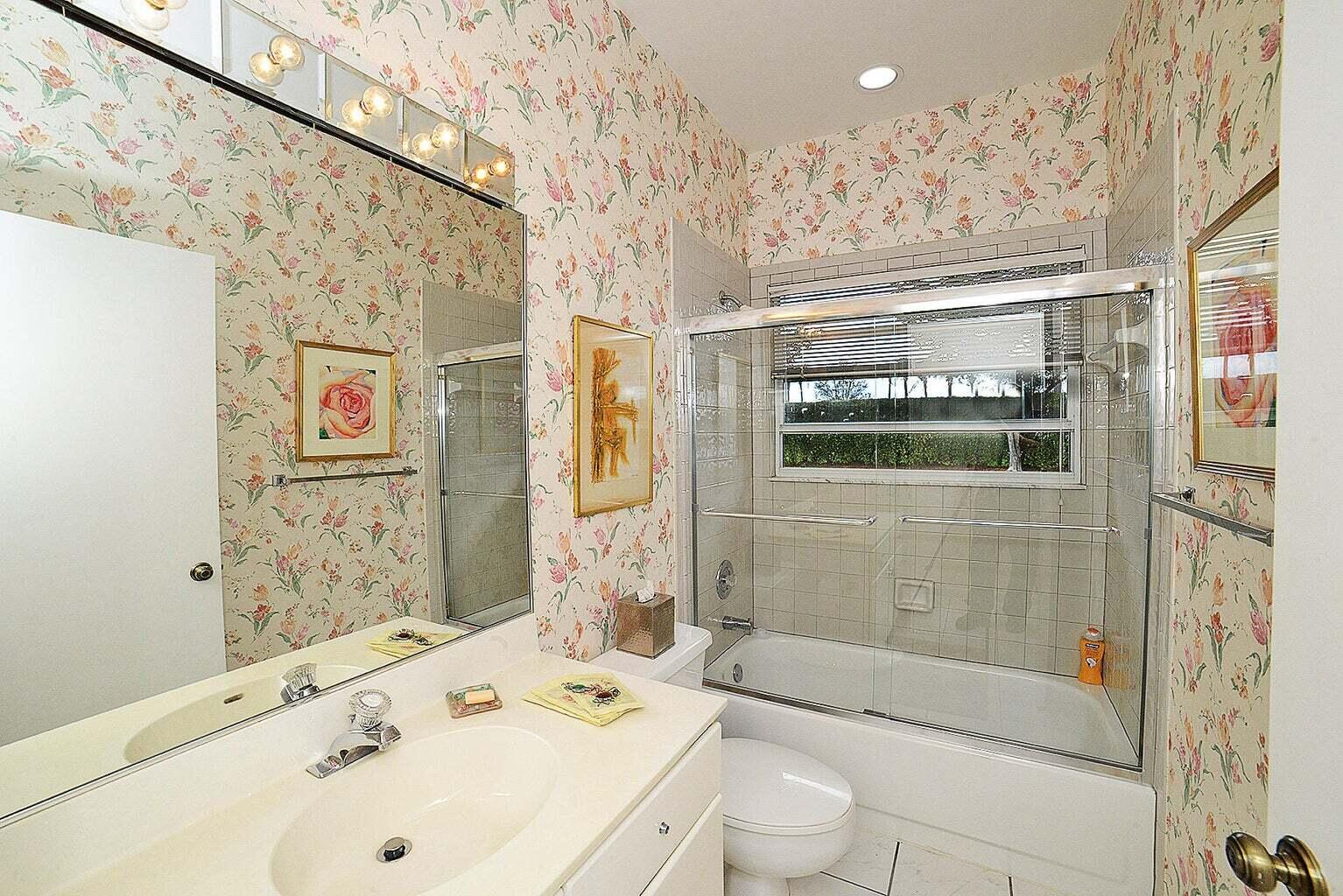 6695 Northwest 25th Court Boca Raton, FL 33496 - Photo 15 of 40 a bathroom with a bathtub shower sink mirror and toilet