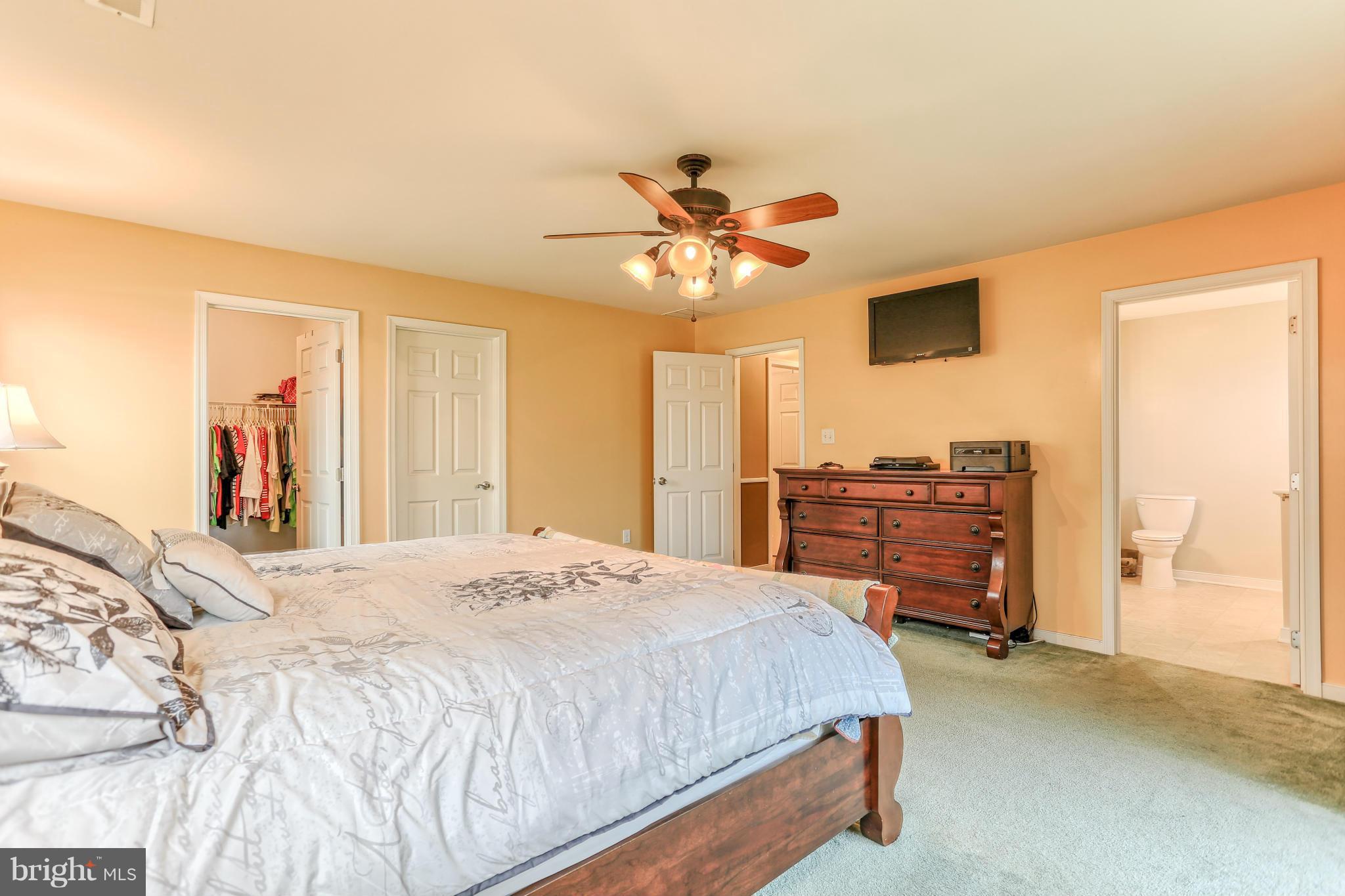 13048 Resh Road Hagerstown, MD 21740 - Photo 4 of 30 a bedroom with a bed and a chandelier