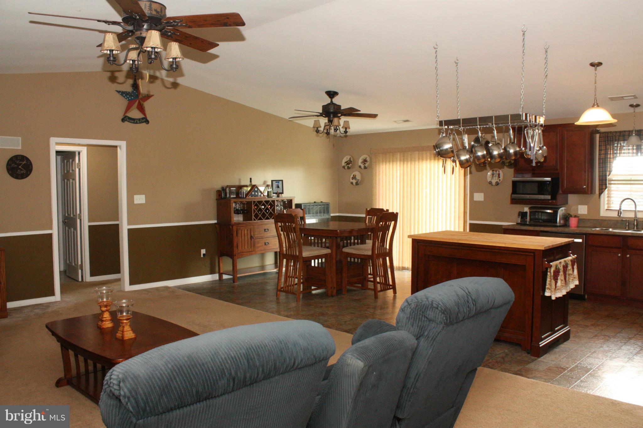 13048 Resh Road Hagerstown, MD 21740 - Photo 8 of 30 a living room with furniture a chandelier and a dining table