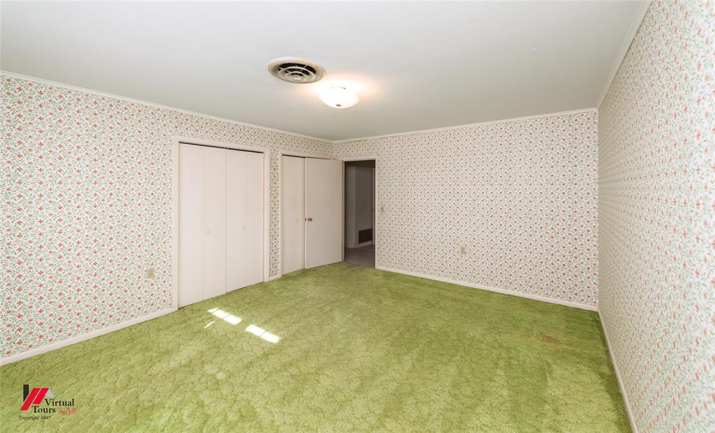 205 7th Street Northeast Springhill, LA 71075 - Photo 36 of 40 Room featuring floral pattern wallpaper, green carpet, and a flush mount ceiling light