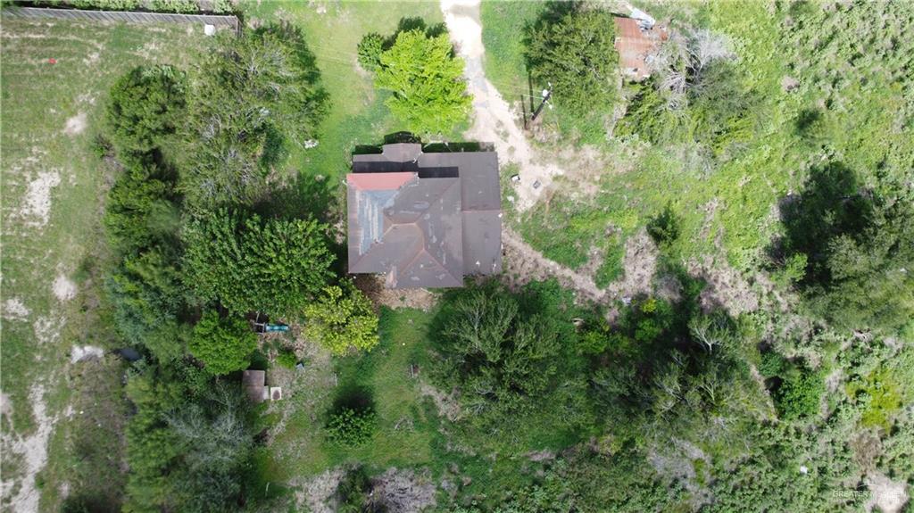 1524 West Hi Line Road Pharr, TX 78577 - Photo 21 of 34 an aerial view of a house with a yard and large trees