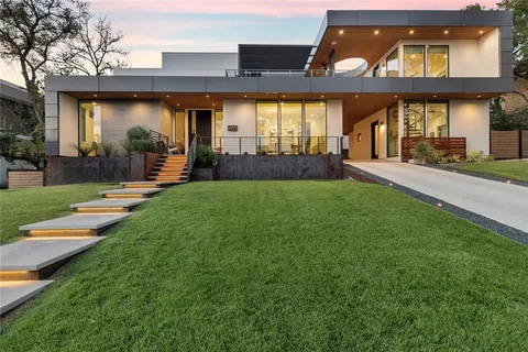a view of a house with sitting area and garden
