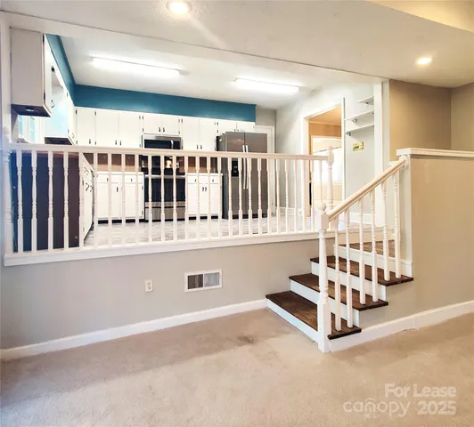 a view of an empty room with stairs