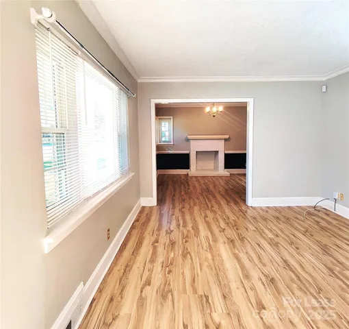 a view of a room with wooden floor and a window