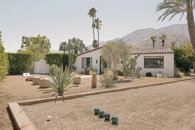a bathroom with a sink a mirror a glass door and shower