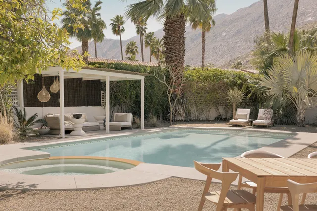 a view of a dining room with furniture and a chandelier