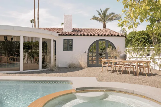a view of a house with backyard and sitting area