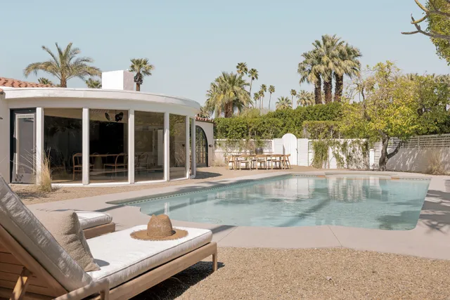 a view of a patio with table and chairs and wooden floor
