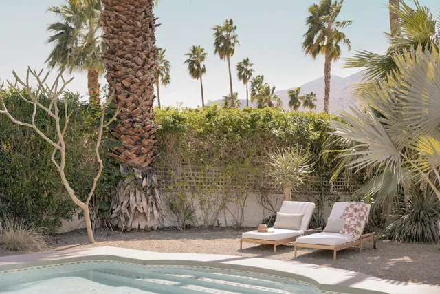 a bedroom with furniture and a large window