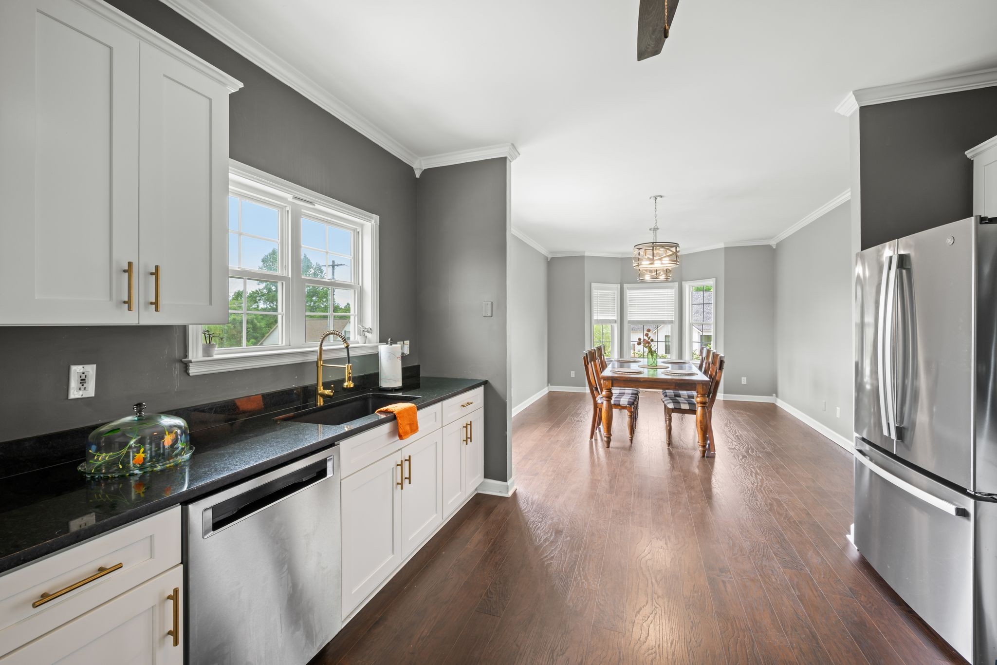 830 Blakemore Road Dickson, TN 37055 - Photo 11 of 22 a kitchen with granite countertop a refrigerator a stove a dining table and chairs with wooden floor