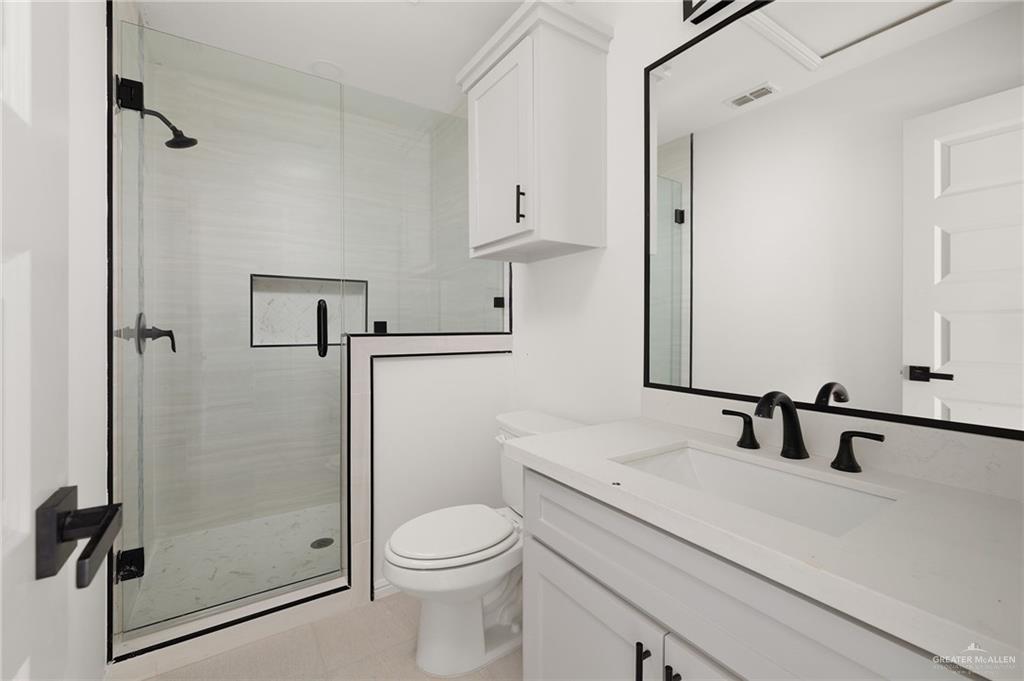 6050 Reymundo Street Edinburg, TX 78542 - Photo 9 of 11 a bathroom with a sink a toilet and shower