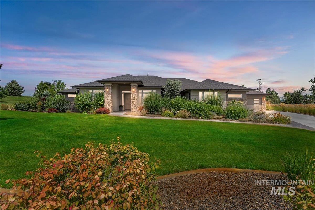 Prairie-style house with a front yard and stone siding