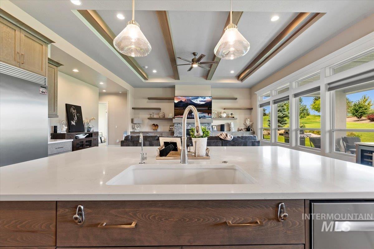 15465 Syrah Court Caldwell, ID 83607 - Photo 50 of 50 Kitchen with open floor plan, a tray ceiling, ceiling fan, appliances with stainless steel finishes, and hanging light fixtures