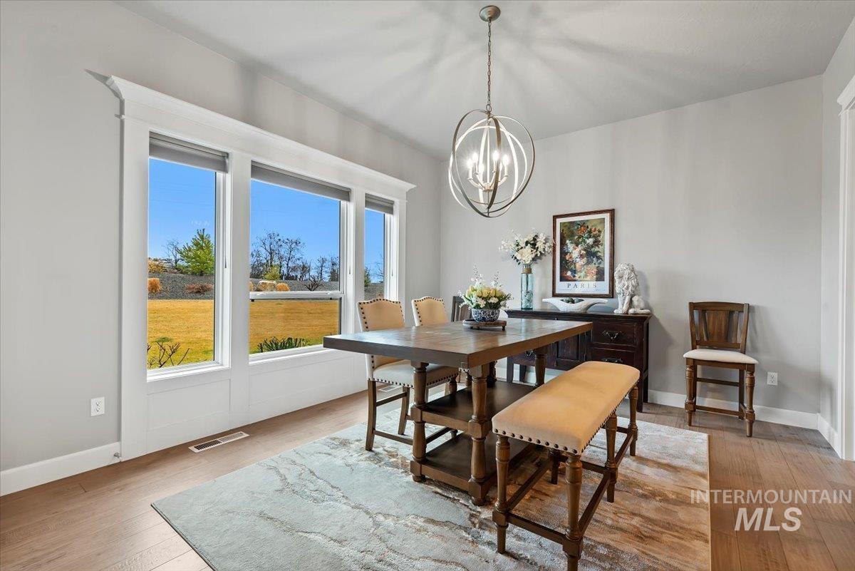 15465 Syrah Court Caldwell, ID 83607 - Photo 15 of 50 Dining area with light wood finished floors and hanging lights