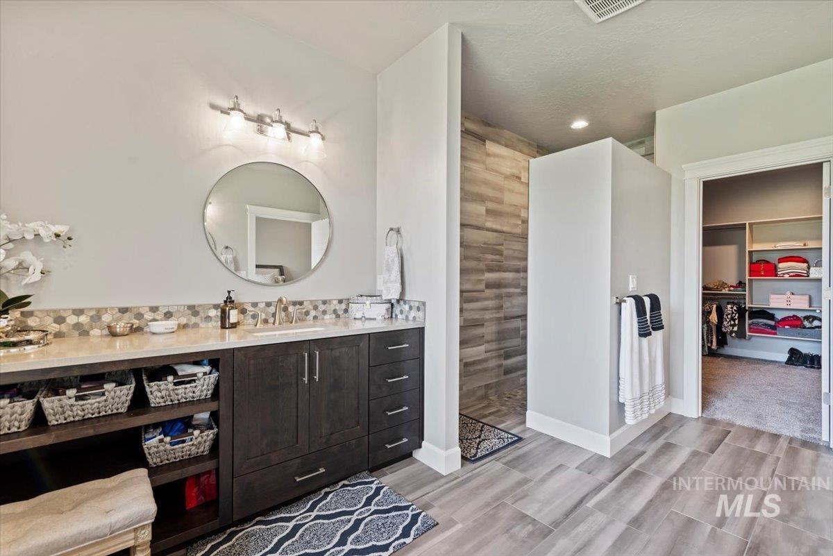 15465 Syrah Court Caldwell, ID 83607 - Photo 19 of 50 Bathroom with walk in shower, vanity, wood finished floors, a spacious closet, and recessed lighting