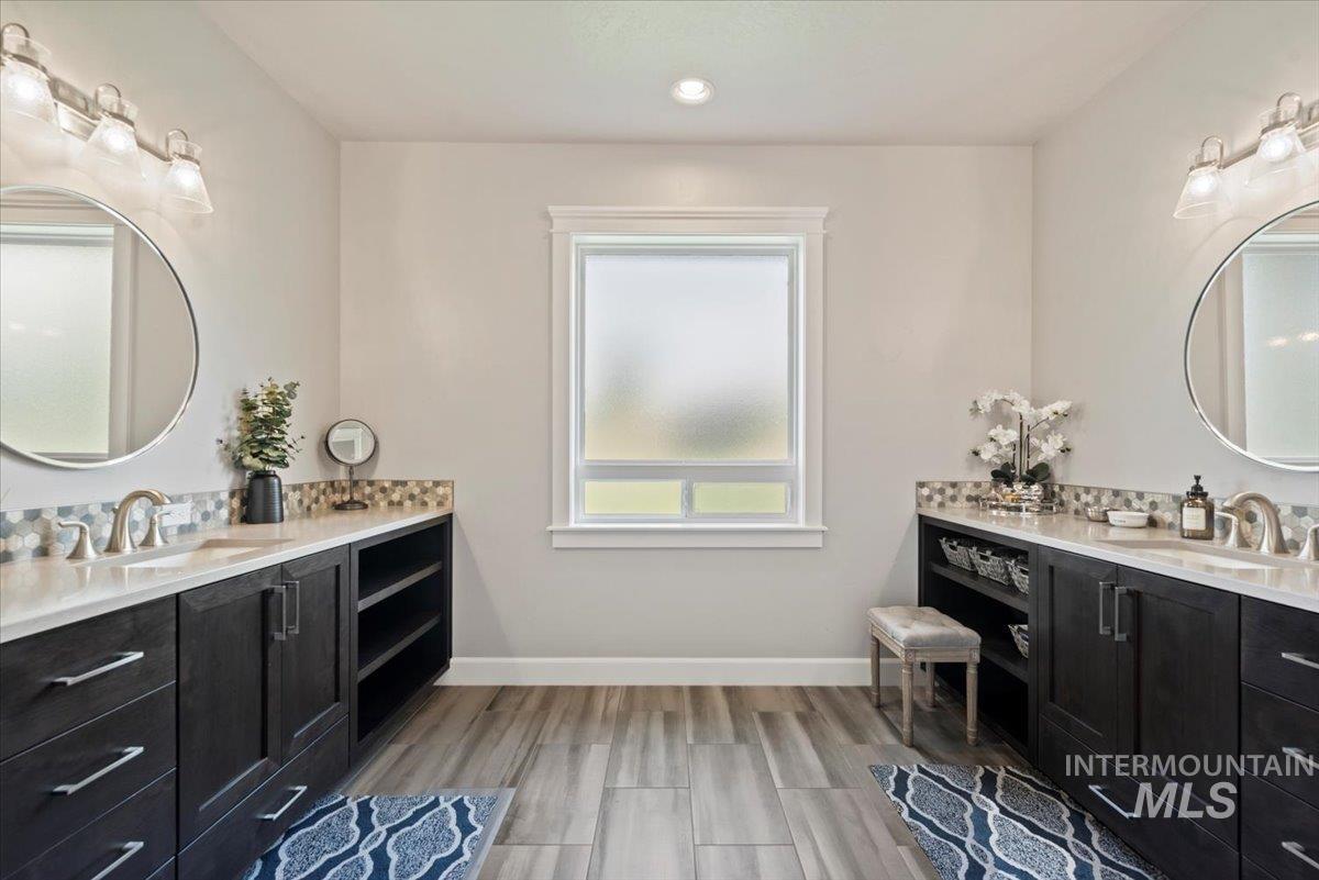 15465 Syrah Court Caldwell, ID 83607 - Photo 20 of 50 Bathroom with two vanities, wood finished floors, and recessed lighting