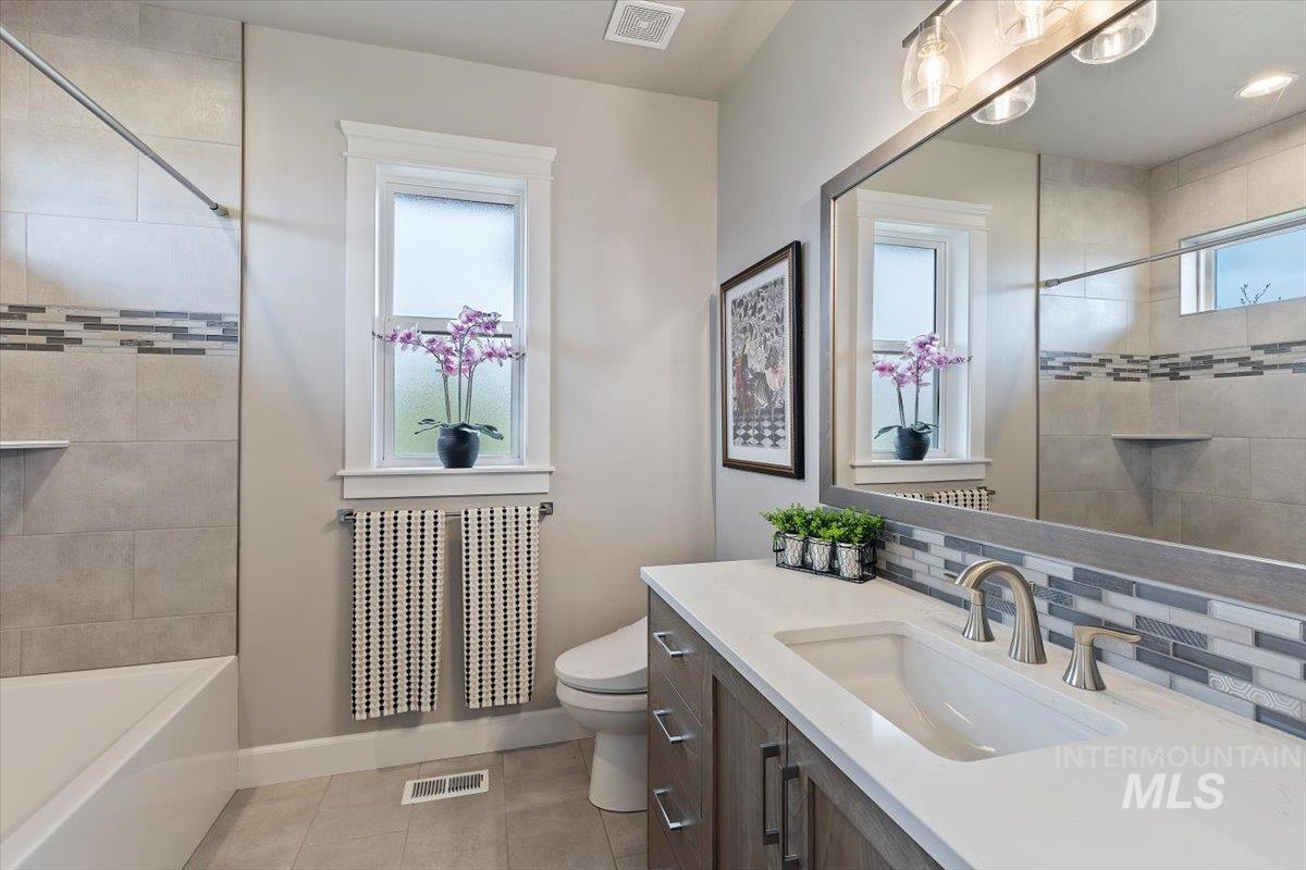 15465 Syrah Court Caldwell, ID 83607 - Photo 26 of 45 Bathroom featuring vanity, light tile patterned flooring, and shower / tub combination