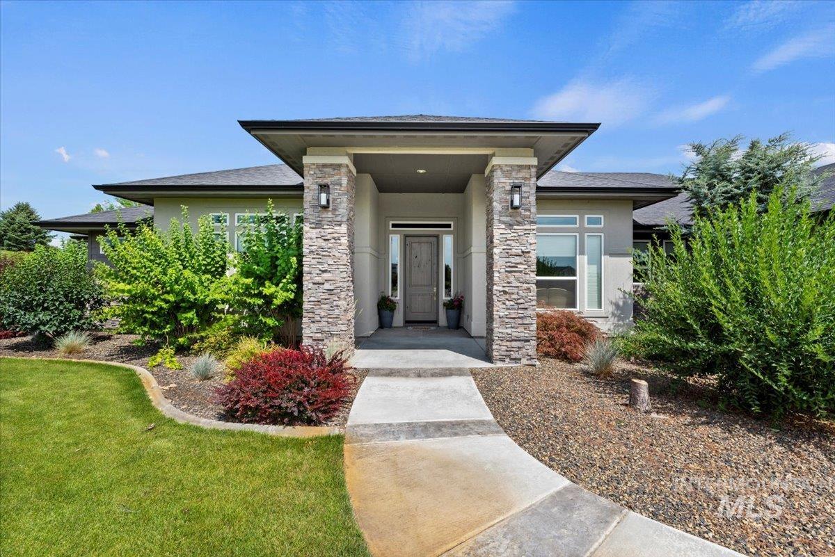 15465 Syrah Court Caldwell, ID 83607 - Photo 5 of 50 Doorway to property with stucco siding and a lawn